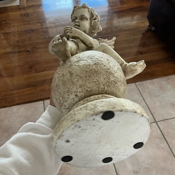 Resin angel statue on a ball 14 1/2 tall 8” wide cream colored